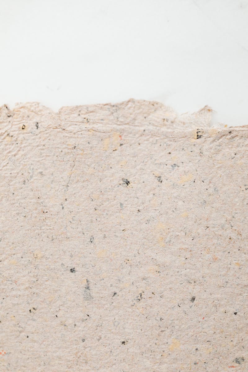 Close-up shot of textured recycled paper with ample copy space for design projects.